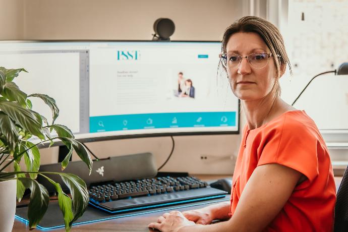 Woman With Orange Dress at a Computer